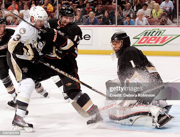 Goalie Jonas Hiller of the Anaheim Ducks defends the net as teammate Lubomir Visnovsky battles Alex Goligoski of the Pittsburgh Penguins on November...