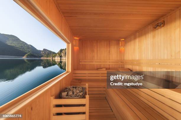 sauna mit blick auf berg und see - bank interior stock-fotos und bilder