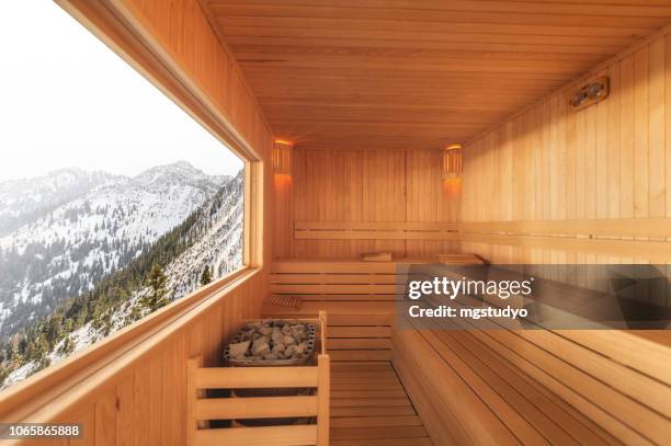 sauna with snowy mountain view - sauna stock pictures, royalty-free photos & images