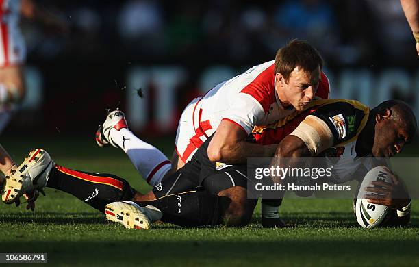 James Roby of England tackles Makali Aizue of Papua New Guinea during the Four Nations match between England and Papua New Guinea at Eden Park on...