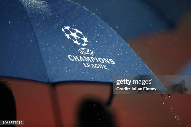 Rain is seen on Champions League logo on an umbrella ahead of an Inter Milan press conference at Wembley Stadium on November 27, 2018 in London,...