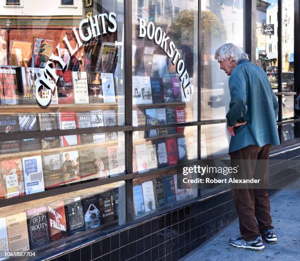 Man peruses a window display at City Lights Bookstore in San Francisco, California. The landmark independent bookstore was founded in 1953 by poet...