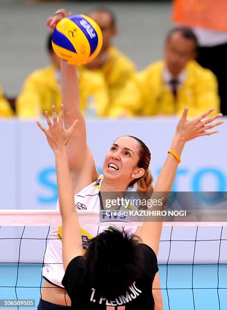 Brazil's Thaisa Menezes spikes the ball over Thailand's Pleumjit Thinkaow during their second round match of the world women's volleyball...