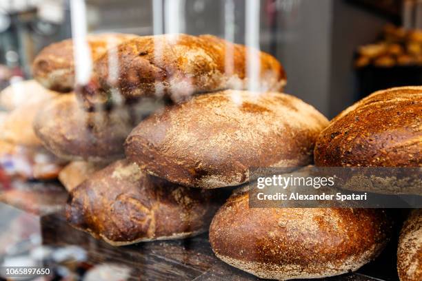 fresh bread on a bakery display - cake shop stock pictures, royalty-free photos & images