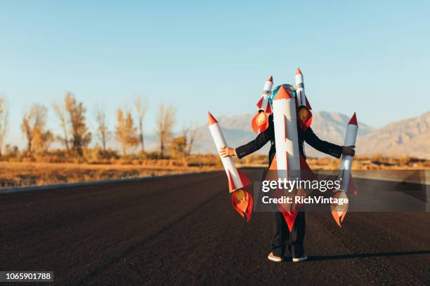 business boy holding rockets - challenge launch stock pictures, royalty-free photos & images