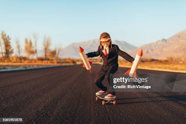 business pojke håller raketer stående på skateboard - launch bildbanksfoton och bilder