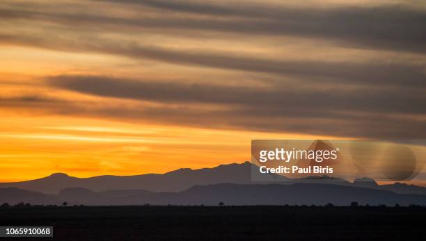 sunset over atlas mountains, near the palmeraie of skoura, in the south morocco - palmeraie stock pictures, royalty-free photos & images