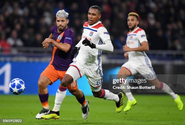 Marcelo of Olympique Lyonnais battles for possession with Sergio Aguero of Manchester City during the UEFA Champions League Group F match between...