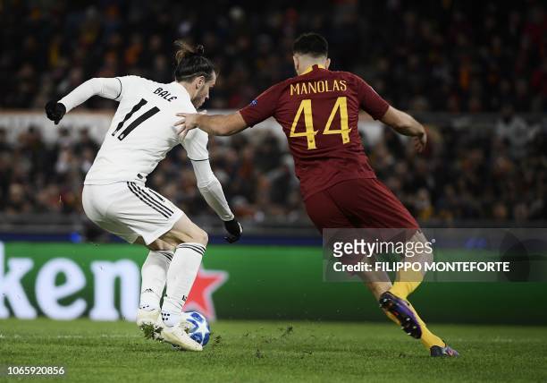 Real Madrid's Welsh forward Gareth Bale prepares to shoot on goal and open the scoring despite AS Roma Greek defender Konstantinos Manolas during the...