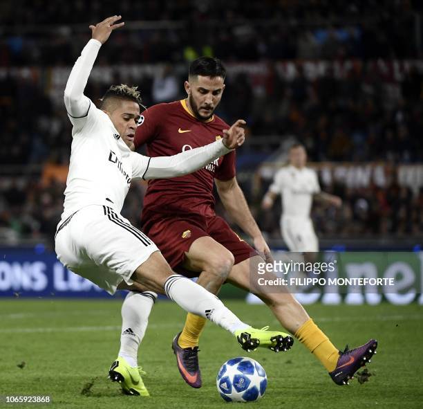 Real Madrid's Spanish-Dominican forward Mariano and AS Roma Greek defender Konstantinos Manolas go for the ball during the UEFA Champions League...
