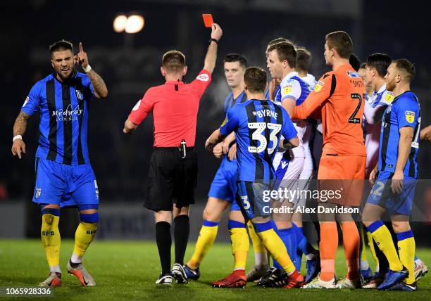 Max Ehmer of Gillingham protests as referee Ollie Yates awards a red card to Callum Reilly during the Sky Bet League One match between Bristol Rovers...