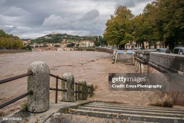 danger of flooding caused by adige river in verona, italy - verona italy stock pictures, royalty-free photos & images