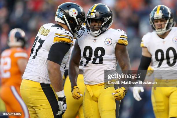 Cameron Heyward and Vince Williams of the Pittsburgh Steelers celebrate Williams' sack of quarterback Case Keenum of the Denver Broncos at Broncos...