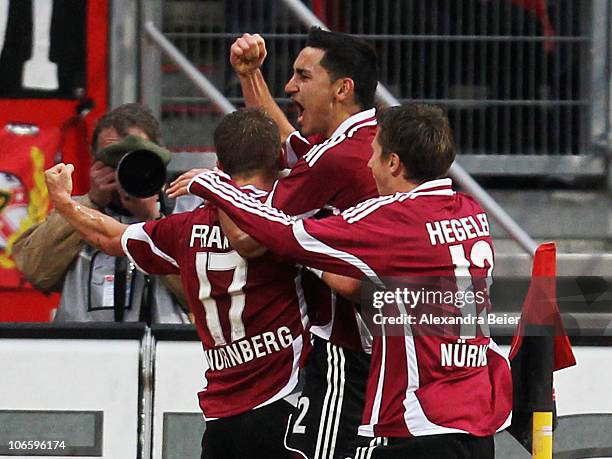 Ilkay Guendogan , Mike Frantz and Jens Hegeler of Nuernberg celebrate Guendogan's first goal during the German Bundesliga match between 1. FC...