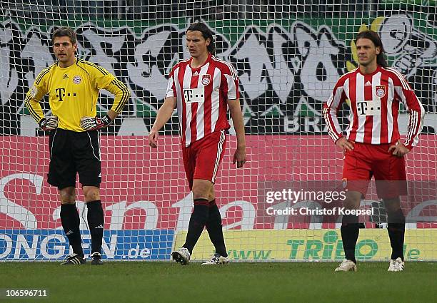 Joerg Butt, Daniel van Buyten of Bayern and Danijel Parnjic look mdejected after the second goal of Gladbach during the Bundesliga match between...