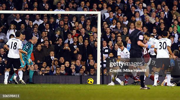 Brede Hangeland of Fulham heads home a last minute equaliser as goalkeeper Brad Friedel of Aston Villa can only watch during the Barclays Premier...