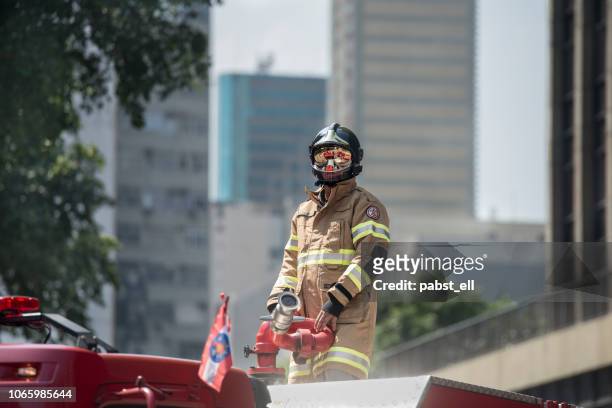 firefighter bombeiro fire retardant coverall alone - bombeiro stock pictures, royalty-free photos & images