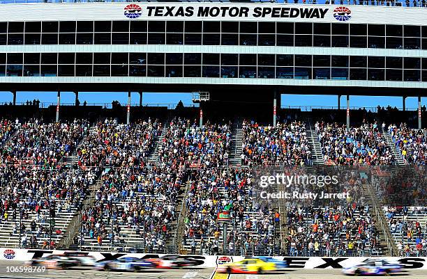 James Buescher, driver of the Wolfpack Energy Services Chevrolet, and Kevin Harvick, driver of the Jimmy John's Chevrolet, lead the field to the...