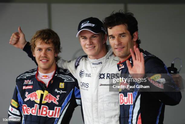 Pole sitter Nico Huelkenberg of Germany and Williams celebrates in parc ferme with second placed Sebastian Vettel of Germany and Red Bull Racing and...