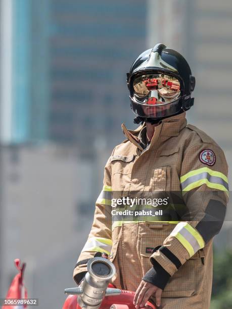 portrait firefighter bombeiro fire retardant coverall - bombeiro stock pictures, royalty-free photos & images