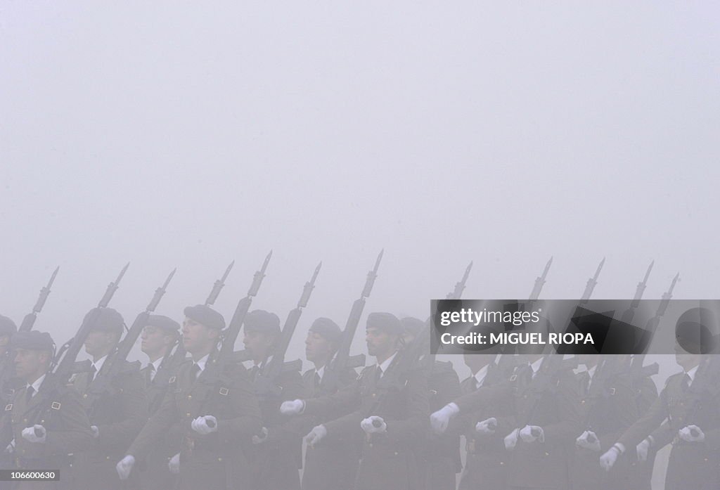 Spanish soldiers march under the fog at