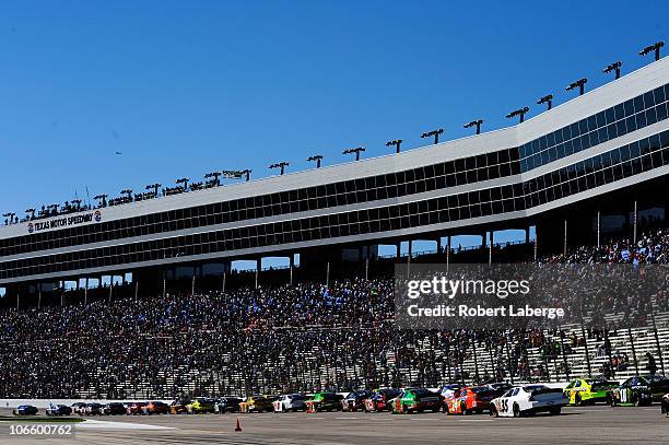 James Buescher, driver of the Wolfpack Energy Services Chevrolet, and Kevin Harvick, driver of the Jimmy John's Chevrolet, lead the field to the...