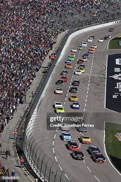 James Buescher, driver of the Wolfpack Energy Services Chevrolet, and Kevin Harvick, driver of the Jimmy John's Chevrolet, lead the field to the...