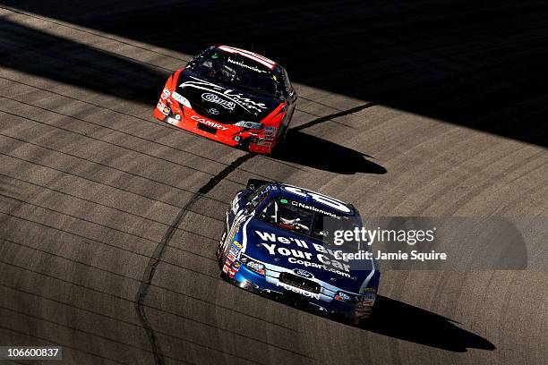 Carl Edwards, driver of the Copart.com Ford, leads Kyle Busch, driver of the Z-Line Designs Toyota, during the NASCAR Nationwide Series O'Reilly Auto...