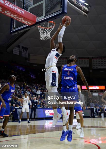 UConn Huskies forward Josh Carlton scores in the post while defended by UMass Lowell River Hawks guard Darius Henderson during the game as the UMass...