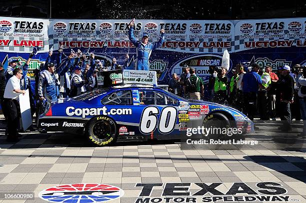 Carl Edwards, driver of the Copart.com Ford, celebrates in Victory Lane after winning the NASCAR Nationwide Series O'Reilly Auto Parts Challenge at...