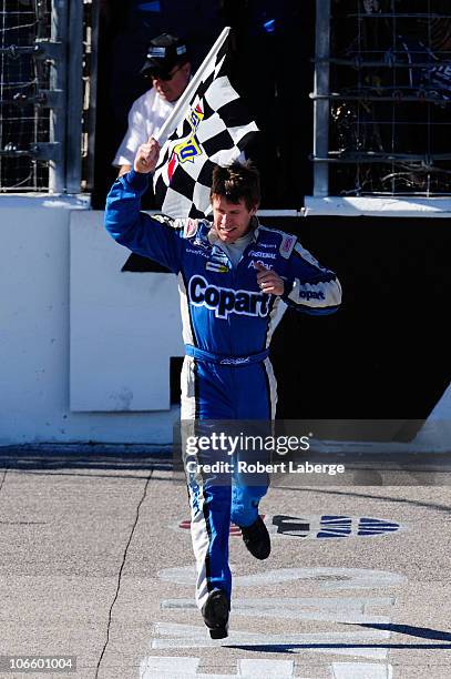 Carl Edwards, driver of the Copart.com Ford, celebrates with the checkered flag after winning the NASCAR Nationwide Series O'Reilly Auto Parts...