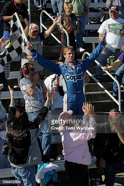 Carl Edwards, driver of the Copart.com Ford, celebrates in the stands after winning the NASCAR Nationwide Series O'Reilly Auto Parts Challenge at...