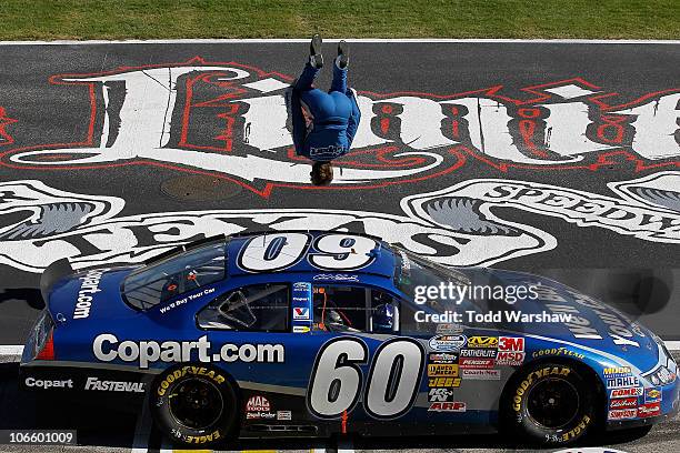 Carl Edwards, driver of the Copart.com Ford, does a back flip as he celebrates after winning the NASCAR Nationwide Series O'Reilly Auto Parts...