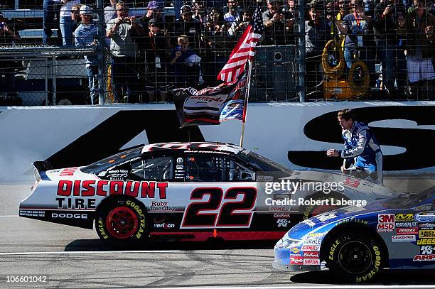 Brad Keselowski, driver of the Discount Tire Dodge, celebrates winning the Nationwide championship with a third-place finish in the NASCAR Nationwide...