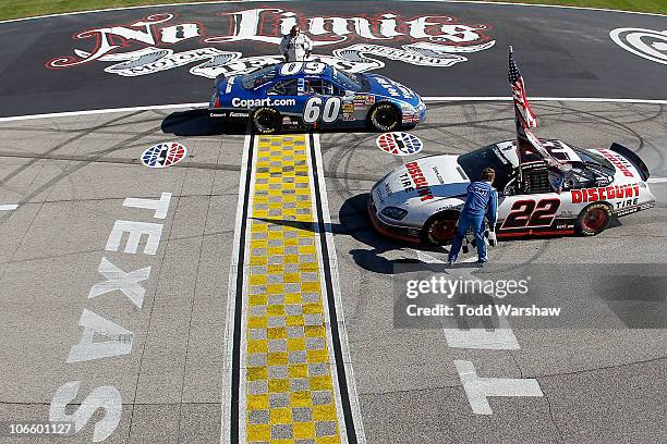 Brad Keselowski, driver of the Discount Tire Dodge, celebrates winning the Nationwide championship with a third-place finish in the NASCAR Nationwide...