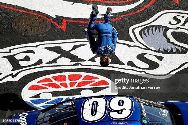 Carl Edwards, driver of the Copart.com Ford, does a back flip as he celebrates after winning the NASCAR Nationwide Series O'Reilly Auto Parts...