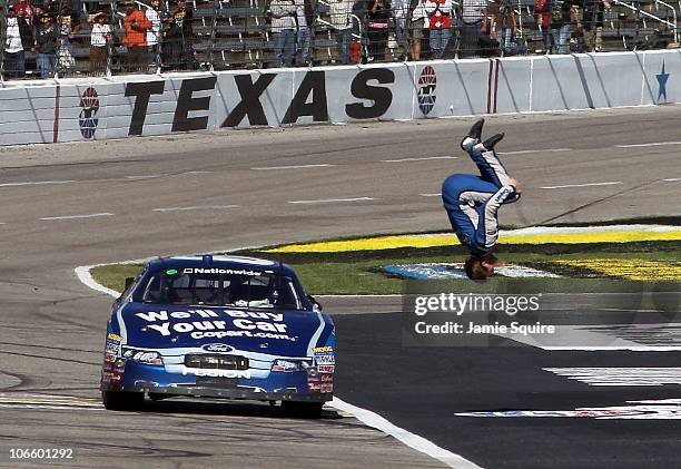 Carl Edwards, driver of the Copart.com Ford, does a back flip as he celebrates after winning the NASCAR Nationwide Series O'Reilly Auto Parts...