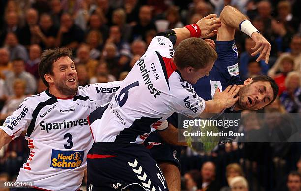 Blazenko Lackovic of Hamburg is blocked by Oscar Carlen of Flensburg during the Toyota Handball Bundesliga match between HSV Hamburg and SG...