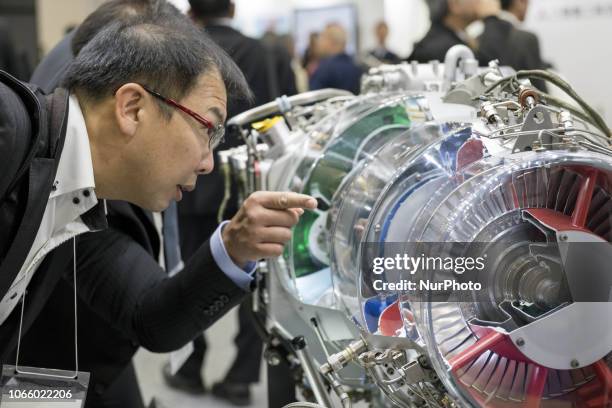 Visitor looks at A visitor looks at Mitsubishi Heavy Industries' engine during Japan Aerospace 2018 air show in Tokyo, Japan, November 28,...