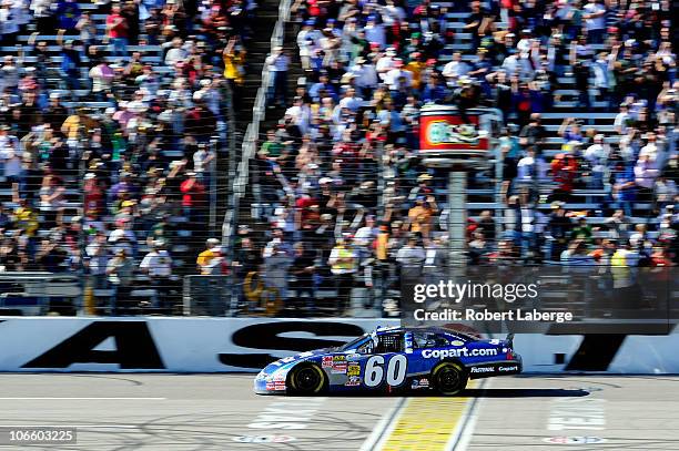 Carl Edwards, driver of the Copart.com Ford, crosses the finish line to win the NASCAR Nationwide Series O'Reilly Auto Parts Challenge at Texas Motor...