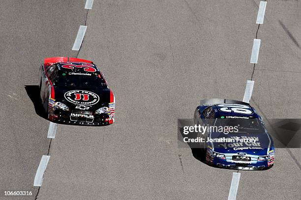 Carl Edwards, driver of the Copart.com Ford, races Kevin Harvick, driver of the Jimmy John's Chevrolet, during the NASCAR Nationwide Series O'Reilly...