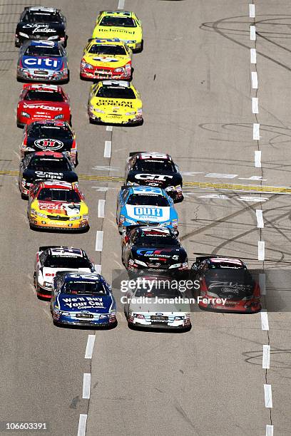 Carl Edwards, driver of the Copart.com Ford, Trevor Bayne, driver of the Roush Fenway Ford, and Kyle Busch, driver of the Z-Line Designs Toyota, lead...