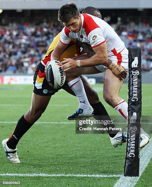 Tom Briscoe of England is taken out over the sideline during the Four Nations match between England and Papua New Guinea at Eden Park on November 6,...