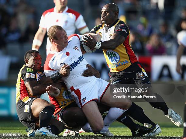 Garreth Carvell of England is brought down during the Four Nations match between England and Papua New Guinea at Eden Park on November 6, 2010 in...