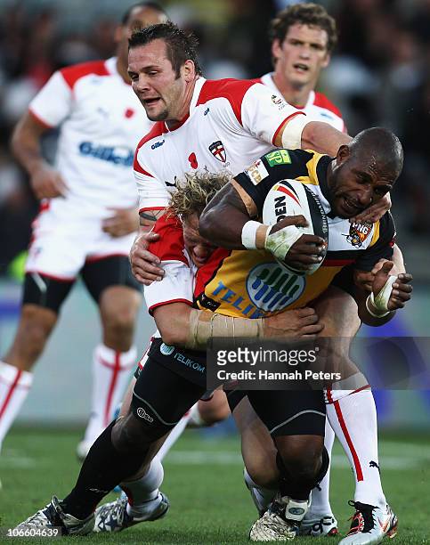 Ben Westwood and Darrell Griffin of England tackle jessie Joe Parker of Papua New Guinea in the tackle during the Four Nations match between England...