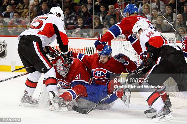 Zach Smith of the Ottawa Senators pushes Dustin Boyd of the Montreal Canadiens into teammate Carey Price during the NHL game at the Bell Centre on...