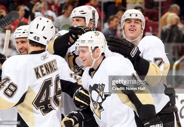 Mark Letestu of the Pittsburgh Penguins is congratulated by teammates Tyler Kennedy and Evgeni Malkin after scoring the game-winning shootout goal...