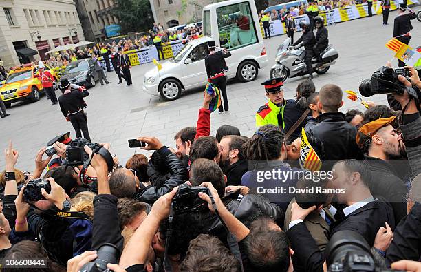 Gay activists take part in a protest by kissing each other in front of Pope Benedit XVI as he passes by on his way to the La Sagrada Familia on...