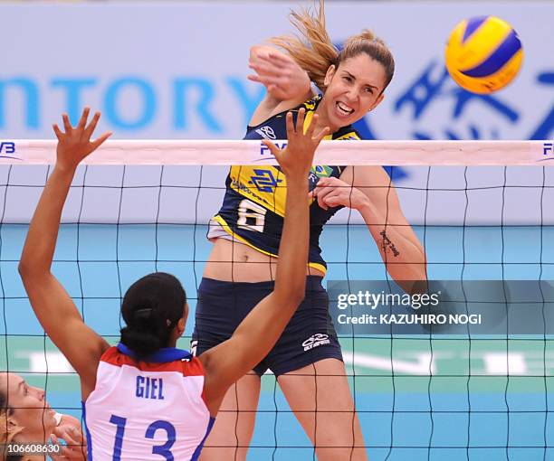 Brazil's Thaisa Menezes spikes the ball over Cuba's Rosanna Giel Ramos during their second round match at the World Women's Volleyball Championship...