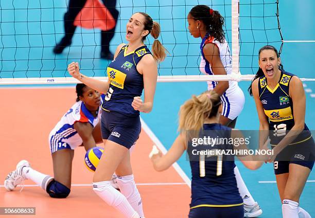 Brazil's Thaisa Menezes and Sheilla Castro celebrate their a block point against Cuba during their second round match at the World Women's Volleyball...